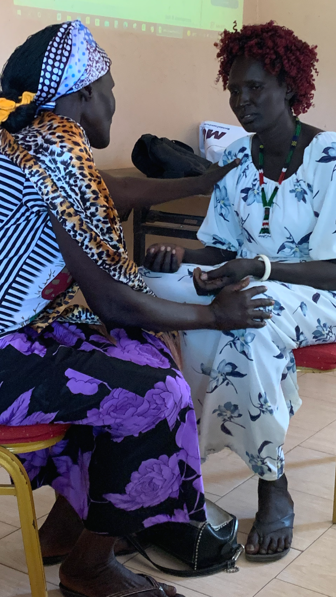 Two women participate in an individual trauma healing session in Rumbek North County, Lake State, South Sudan